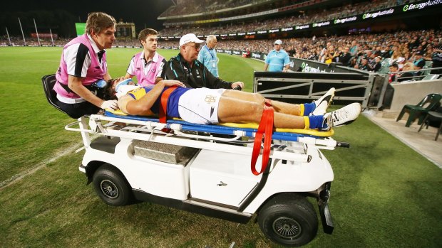 Andrew Gaff is taken from the field after the head high clash.