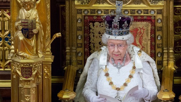 Elizabeth II, wearing the Imperial State Crown, delivers the Queen's Speech to Parliament in the House of Lords last year.