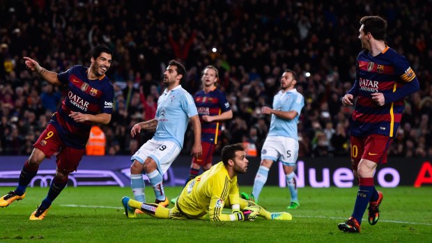 Cheeky move: Luis Suarez celebrates with his team mate Lionel Messi.
