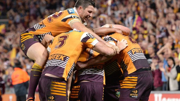 On a roll: Broncos players celebrate at the final whistle.