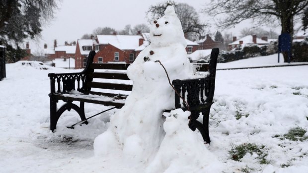 A snowman and dog on a bench in Worcester, England on  Sunday.