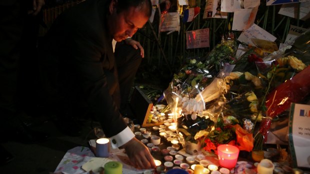 Josh Frydenberg placed flowers and lit a candle at the Bataclan memorial in Paris during a recent visit.
