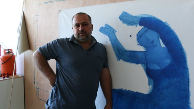 Palestinian artist Ayman Eissa, 41, with one of his unfinished works. 