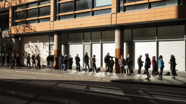 People queue around the block at the Passport Office in Sydney last month.