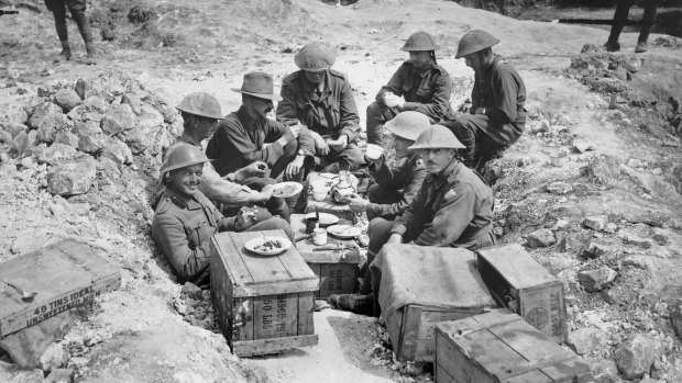 A group of Australian officers having breakfast in a shell hole in Sausage Valley in the forward area near Pozieres, France.