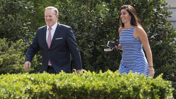 Sean Spicer, outgoing White House press secretary, left, smiles while walking to the West Wing with Vanessa Morrone, advisor to the White House Press Secretary on Thursday.
