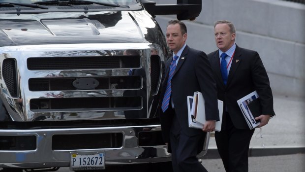 Donald Trump's chief of staff Reince Priebus, left, and incoming press secretary Sean Spicer, right, walk to their bus at the Eisenhower Executive Office Building in Washington.