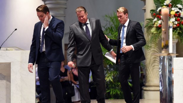 Mitchell, Steven and Billy Miller leave the altar after delivering the eulogy at Cole Miller's funeral service.