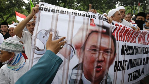 Muslim protesters hold a banner calling for the arrest of Jakarta Governor Basuki Tjahaja Purnama, popularly known as Ahok, outside City Hall in Jakarta.