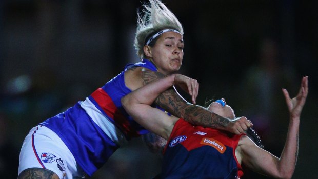 Western Bulldog Moana Hope collects a Demons player during the AFL women's all-star exhibition match this month.