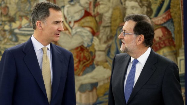 King Felipe talks with Spain's now acting Prime Minister Mariano Rajoy at the Zarzuela Palace in Madrid on Tuesday.