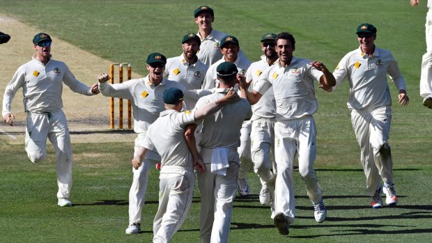 Sweet victory: Australian players celebrate after the final wicket.