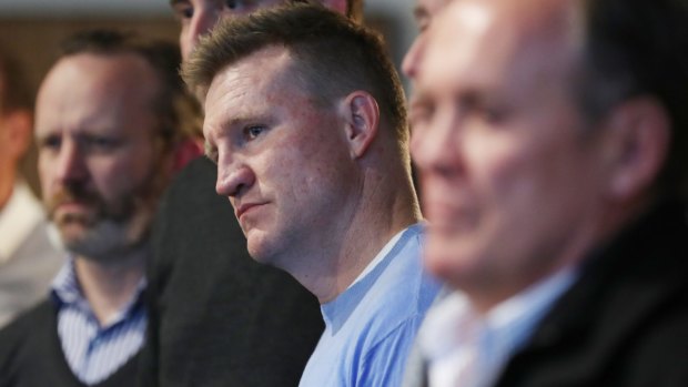 Collingwood coach Nathan Buckley watches as CEO Gary Pert announce his resignation.