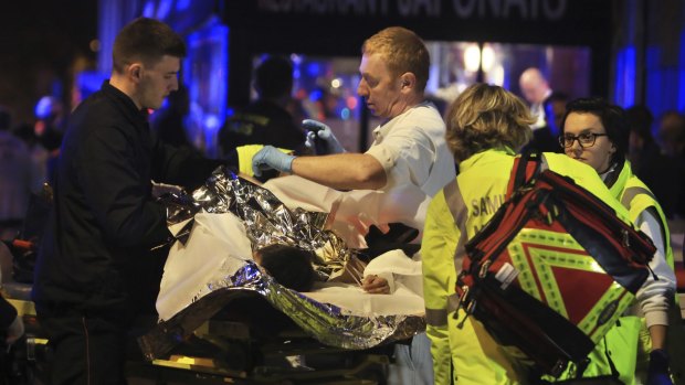 Emergency workers in Paris helping the injured in the Bataclan theatre.