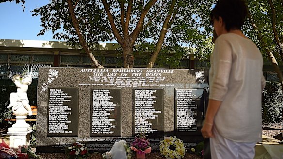 A woman looks at the Granville train disaster memorial that names the 83 people who died 40 years ago.