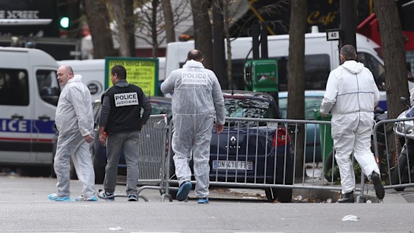 Police enter the Bataclan theatre where dozens were killed.