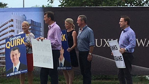 Lord Mayor Graham Quirk with some of his successful LNP team thank motorists at Kangaroo Point after being re-elected.