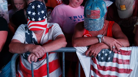 Red, white and blue: Supporters of Republican presidential candidate Donald Trump pray during a campaign rally in Panama City, Florida.