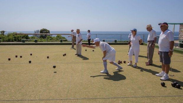 A group of retired Italian-Australians enjoy the sea air and view over a game of bocce at Clovelly.