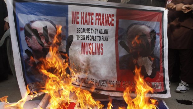 Posters featuring France's President Francois Hollande are set alight during anti-Charlie Hebdo protests in Quetta, Pakistan, on Sunday. 