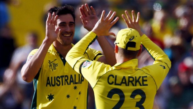 Leading from the front: Mitchell Starc celebrates the wicket of Pakistan's Wahab Riaz with captain Michael Clarke.