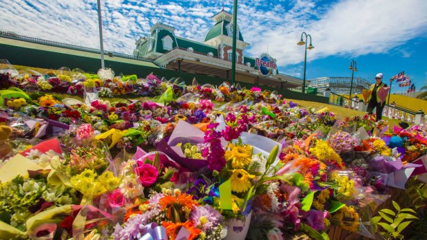 Flower tributes at Dreamworld after the deaths of four people last year.