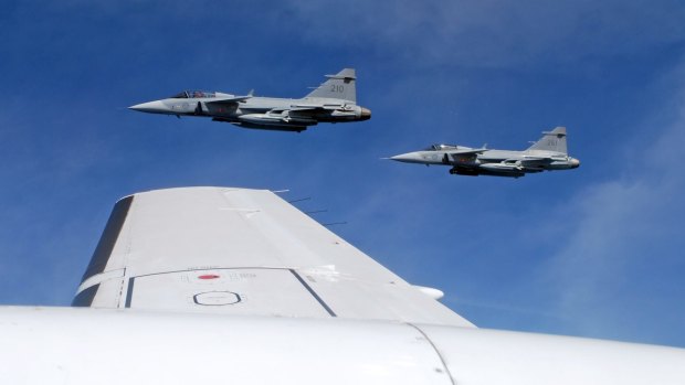 Saab JAS 39C Gripen fighter jets from F17 Wing of the Swedish Air Force demonstrate a mid-air interception over Sweden.