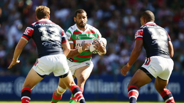 Hard to stop: Greg Inglis takes on the defence during the round one NRL match between the Sydney Roosters and the South Sydney Rabbitohs at Allianz Stadium.