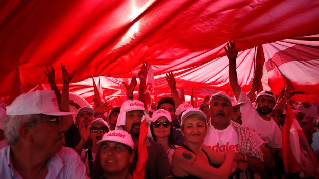 Supporters of Kemal Kilicdaroglu hold a huge Turkish flag.