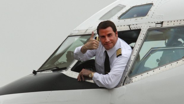 John Travolta sits in the cockpit of his Boeing 707 in June 2002.