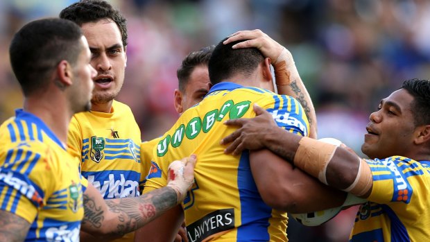 Eels team-mates celebrate a try during their clash against the Knights in Newcastle. 