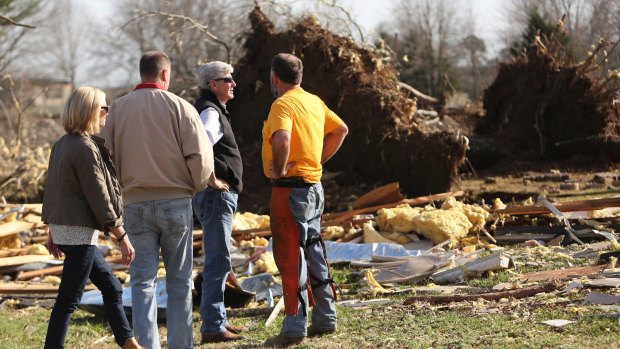 Mississippi Governor Phil Bryant, centre right, inspects tornado damage in Ashland, Mississippi. 