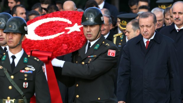 Turkish President Recep Tayyip Erdogan, right, follows a military honour guard to the mausoleum of the republic's founder Mustafa Kemal on October 29,  Republic Day.