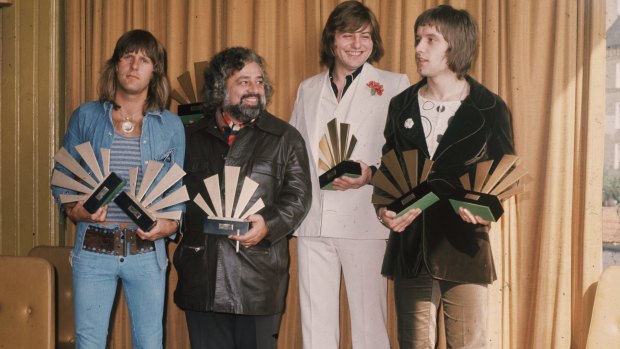 Keyboardist Keith Emerson, lead singer and bassist Greg Lake (in white)  and drummer Carl Palmer with American disc jockey and singer Wolfman Jack (2nd left)