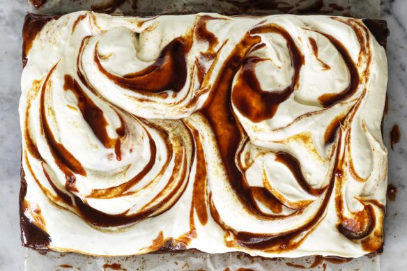 A slab of banana cake with cream cheese icing and swirls of optional  miso caramel.