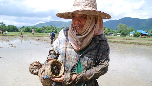 A woman shows her catch at Baan Mae.