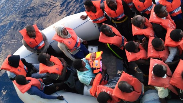 Migrants in a dinghy are rescued by the vessel Burbon Argos, run by Medecins sans Frontieres, in the Mediterranean sea.