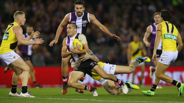 St Kilda's Shane Savage is brought down by the Richmond defence.