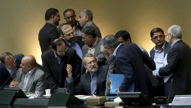 Iran's parliament speaker Ali Larijani, centre, speaks with lawmakers in an open session of parliament while discussing a bill on Iran's nuclear deal with world powers, in Tehran on Tuesday. 