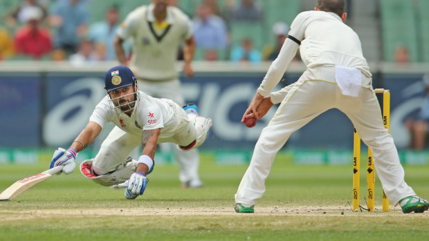 MELBOURNE, AUSTRALIA - DECEMBER 30: Virat Kohli of India dives to make his ground as Nathan Lyon of Australia misses a run out opportunity during day five of the Third Test match between Australia and India at Melbourne Cricket Ground on December 30, 2014 in Melbourne, Australia. (Photo by Scott Barbour/Getty Images)