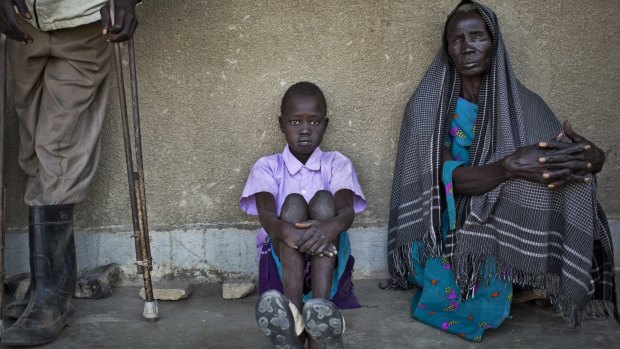 People displaced by fighting between government and rebel forces in Bor queue for medical care at a clinic run by Medecins Sans Frontieres in Awerial, South Sudan. 