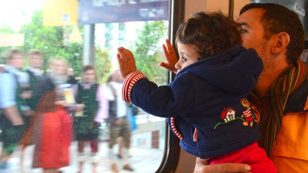 Eight-month-old Maria and her father, Ibrahim, are pictured on a train going from Salzburg in Austria to Munich on Germany. They are among thousands of people to have fled Damascus since the start of the Syrian war.