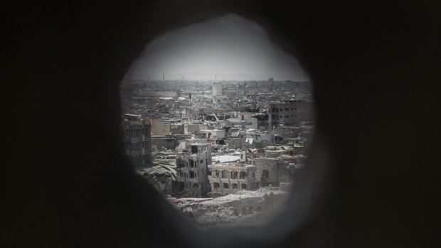 The view of Mosul's Old City through an Iraqi forces sniper hole in the wall of a frontline position in Adedat, a neighbourhood in the Old City of west Mosul.