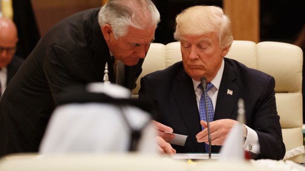 US Secretary of State Rex Tillerson hands a note to US President Donald Trump during a meeting with leaders at the Gulf Cooperation Council Summit in Riyadh on Sunday.