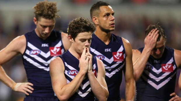 On the slide: Zac Dawson, Lachie Neale, Michael Johnson look on after the Dockers lost to Hawthorn.