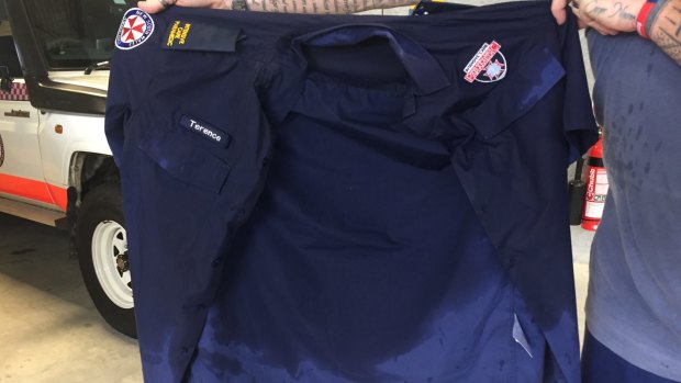 A paramedic over shirt soaked with sweat.