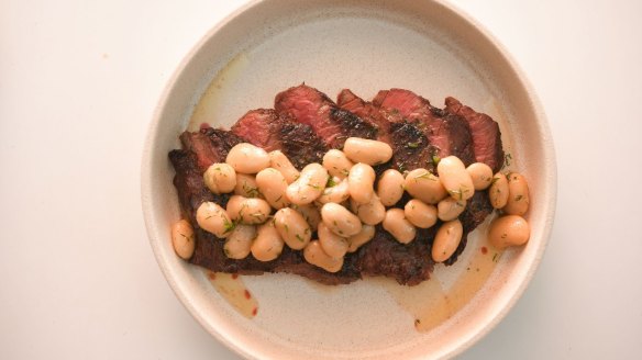 Flank steak with marinated butter beans.