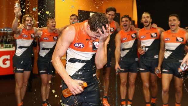 Jacob Hopper of the Giants is sprayed by teammates after GWS's win over the Gold Coast Suns at Spotless Stadium on Saturday.