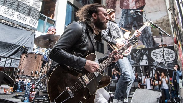Aussie rock band Jet perform a pop-up gig in ACDC Lane on Tuesday as part of a tour announcement.