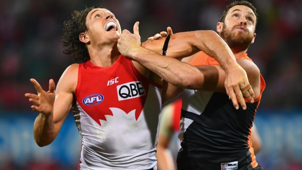 Cross-town tussle: Kurt Tippett and Shane Mumford jostle for possession.